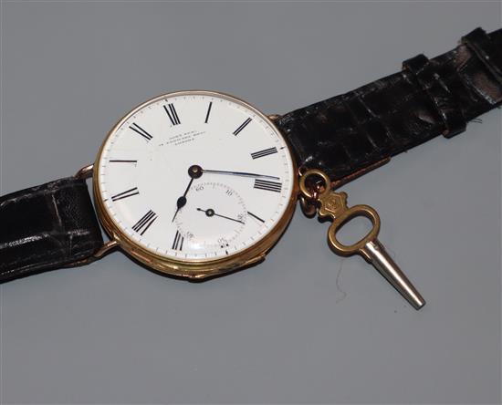 A yellow metal fob watch with Roman dial and subsidiary seconds by John Neal, now converted to a wrist watch.